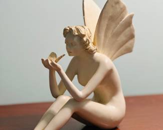 This is a vintage A. Santini fairy statue reproduction made from a heavy resin or bonded marble composition.
