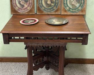 This is an antique Victorian Eastlake style parlor table featuring a carved walnut base 
