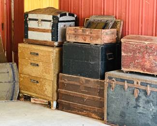 Collection of assorted antique steamer trunks 