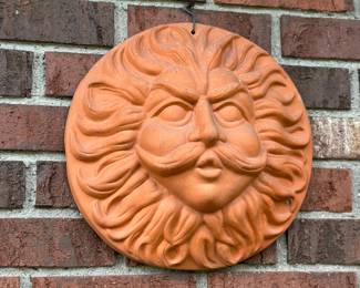 Terracotta sun face wall plaque, often depicting "Old Man Winter" 