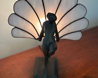 Vintage Art Deco style table lamp featuring a metal nude female figure holding a fan-shaped stained glass