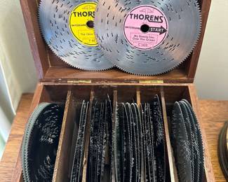 Thorens AD30 automatic disc music box set with multiple discs in a wooden storage case.