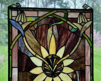 This is a floral stained glass window panel in the Art Nouveau style