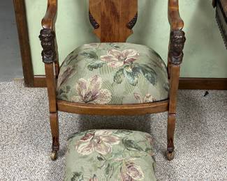This armchair and footstool set is an antique Victorian parlor chair, with  sculpted female heads (busts)