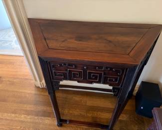 $1900. Chinese console table with one drawer wedge shaped rosewood. Raised Greek key fret work design. Ching Dynasty. 38 inches wide by 16 inches deep by 34 inches high.