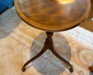 $240. One of a pair of mahogany oval drinks tables each measures 16 1/2 inches wide by 12 1/2 inches deep by 22 1/2 inches high.
