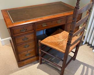 Antique leather top desk 47 inches wide by 26 1/2 inches deep by 29 inches high. Ladder back chair with rush seat is also for sale.