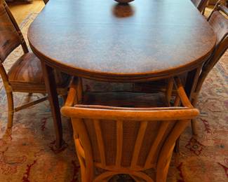 $3600 Vintage McGuire dining set includes eight chairs, one of which is upholstered in a different fabric as shown in a following picture. Table is 45 inches wide by 79 1/2 inches long by 29 inches high as shown. Two 18” inch leaves are installed. Table length can become flexible.
