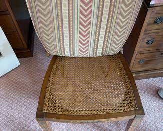 Caned seat on one, as found chair in next photo