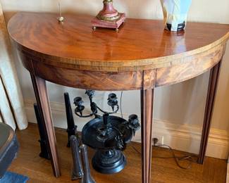 $450. Demi-lune game table with fold down top. 40 inches wide by 18 inches deep by 29 inches high. When open turns into a 36 inch round.