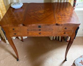 Antique French Louis XV style vanity table featuring intricate marquetry, a concealed mirror and multiple drawers. 31"w x 19.5"d x 34"h as shown, 43"h with mirror open.