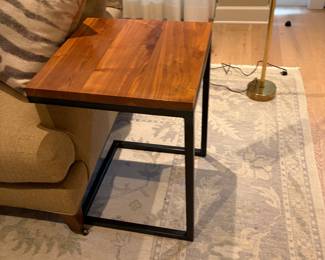 Square side table, metal base tuck in as closely to a sofa or chair as you want. 18 in.² by 25 inches high.
