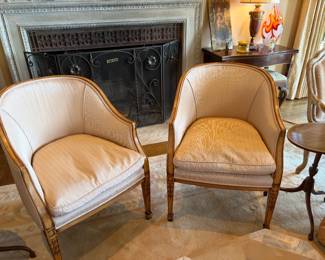 $660. A pair of barrel chairs upholstered in striped fabric. 24 1/2 inches wide by 23 inches deep by 33 inches high.