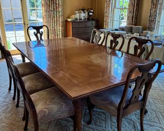 Dining table and 8 chairs. leaves each 22" w. Shown here it is 57"w 100" d x 30"h. Some as found areas shown in next photos. Four additional 22" leaves.