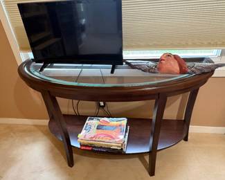 Demi-lune console table with glass top and lower tier, coffee table books, smaller TV - great for the kitchen and more!
