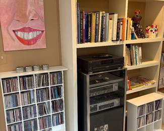 Stereo cabinet, stereo system, CDs, books, artwork, and Toby Mugs