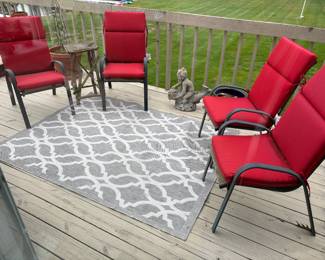 Patio chairs with cushions, outdoor rug, side table and cement sculptures