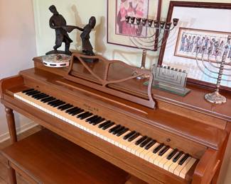 Piano with menorahs and Judaica arwork and bronze
