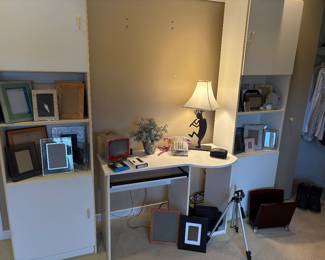 Desk, lamp, side cabinets with shelves, tri-pods, and picture frames