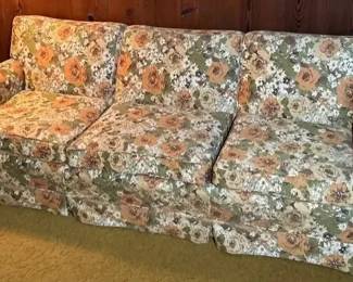 Flower Print Couch With Brass Floor Lamps And Mirror