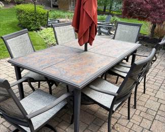 Patio dining table with tile top, 6 chairs (2 arm and 4 side), umbrella with stand and table cover