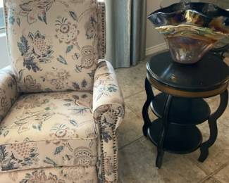 A Floral Print Swivel Rocker Recliner With Rolled Arms., A Side Table And More