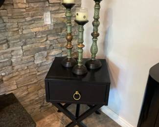 A Small Wood Accent Table With Three Wood Candle Holders