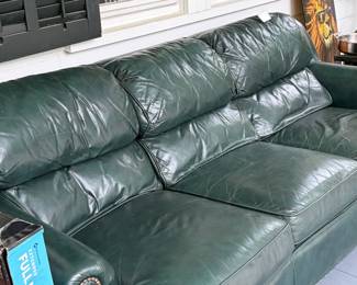 Green leather sofa in fair condition