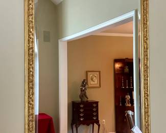 Beveled wall mirror with gilded frame. $250.00