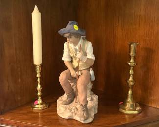 Lladro porcelain figure of a boy, titled "The Journey" ($25.00), brass candlesticks ($10.00 each)