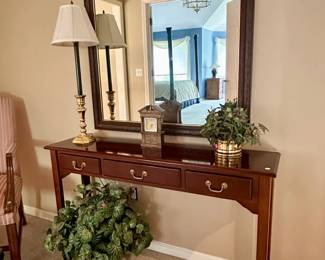 Console table ($100.00), wall mirror ($100.00), decorative shelf clock ($25.00), faux planters ($10.00)
