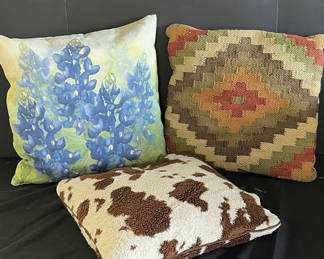 Lot 129: Decorative throw pillows: blue floral, kilim, and cowhide patterns