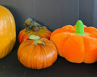 Lot 72: Assorted Halloween decor: plush pumpkins, cow-patterned cushion, and vintage candle box