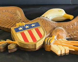 Lot 1: Carved wooden eagle with shield and flag-pattern boards