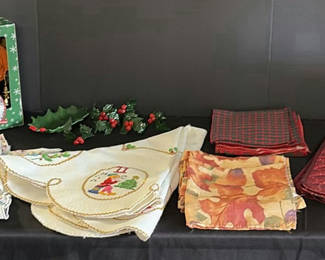Lot 169: Christmas-themed linens and Santa doll with kitchen textiles