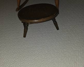 tripod milking stool, likely used for rustic 
