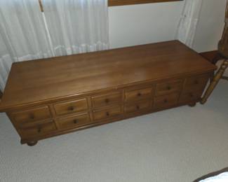 This is a wooden Amish-style 10-drawer credenza with a medium stain finish.