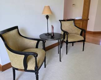 These are French-style ebonized wood frame bergère armchairs featuring gondola curved backs.