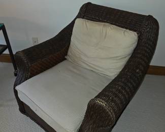 rattan lounge chair with a removable seat cushion and back pillow.