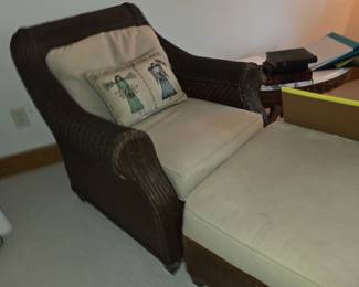 rattan lounge chair with a removable seat cushion and back pillow.
