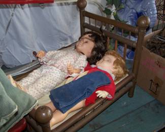 DOLLS IN BRASS DOLL BED