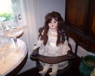ANTIQUE DOLL IN HIGH CHAIR