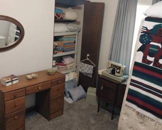 desk, vintage Sears Kenmore sewing machine, oval mirror, linens