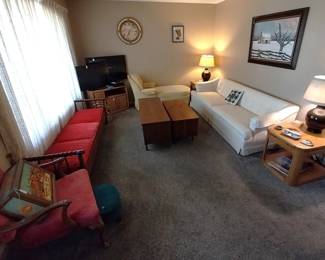 white sofa, mid century modern bench, yellow chaise arm chair, cedar chests, lamps, side tables, Panasonic TV, Samsung TV, Sony blu ray player