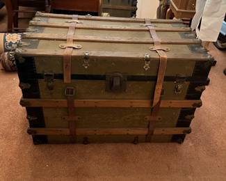 Travel trunk with leather accents.