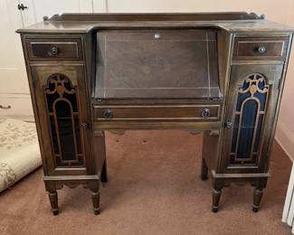 Secretary desk with drop down writing surface and side cabinets.