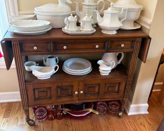 white stoneware serving pieces, including a sweet duck tureen, and a vintage rolling bar/server