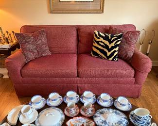 lots of porcelain teacups and an Ethan Allen sofa