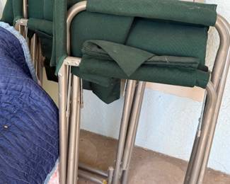 Two green canvas folding chairs