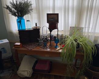 Sofa table, metal pieces, small wood jewelry box with drawers, blue glass vase, plant